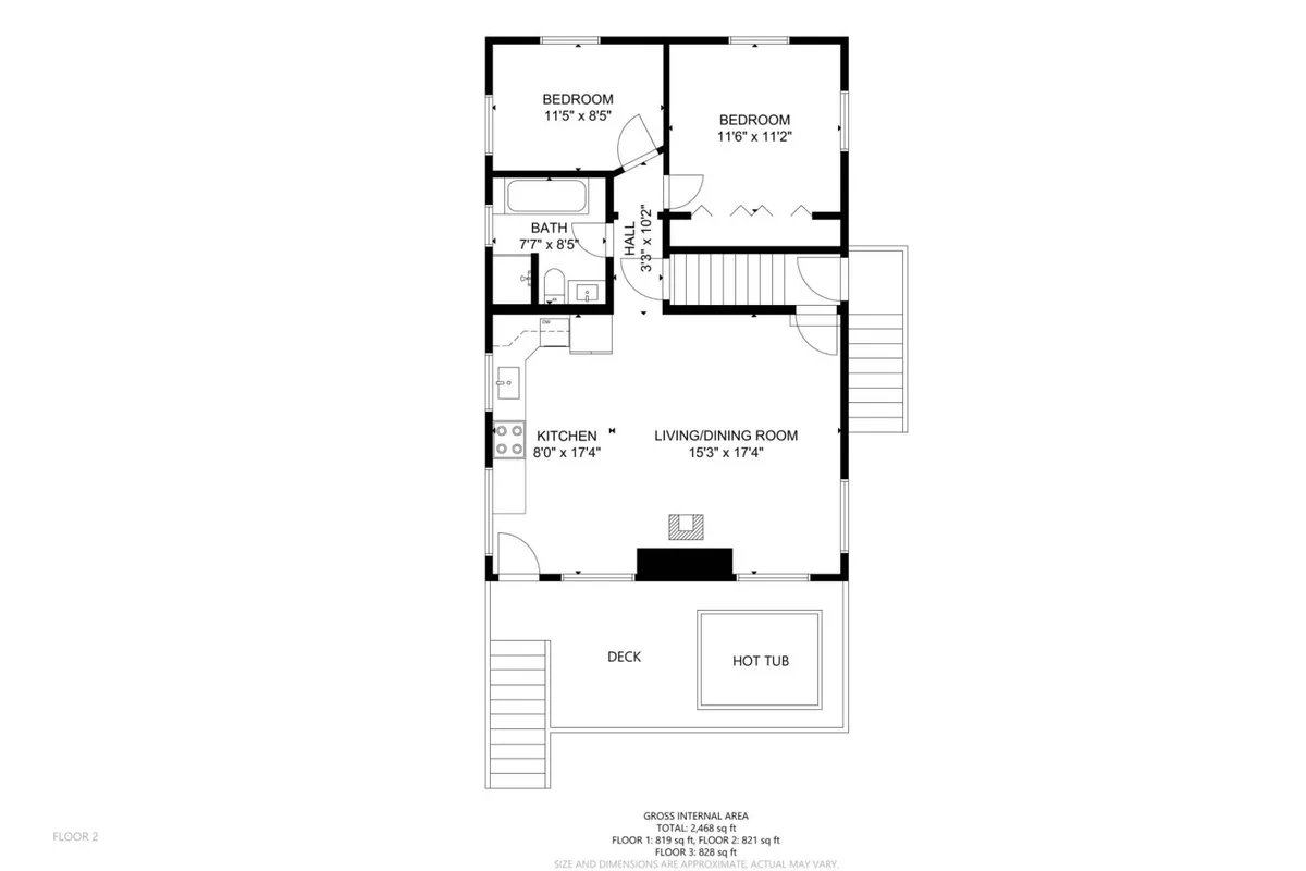 An inviting view from inside the home, showing the open-plan kitchen, living, and dining area with direct access to the deck and hot tub outside. Warm lighting and cozy furnishings create a welcoming atmosphere, while large windows and glass doors showcase the seamless indoor-outdoor connection.